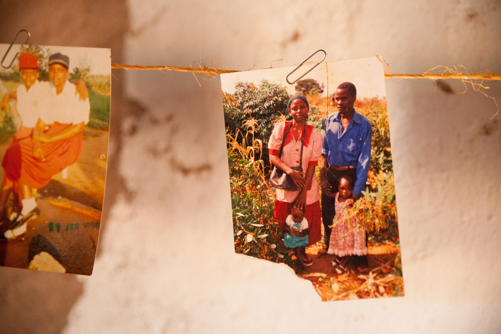 String holding up smaller photos of Kisilu and his family